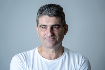 Fototapeta premium Close up portrait of a middle age man in neutral poker facial expressions and human emotions