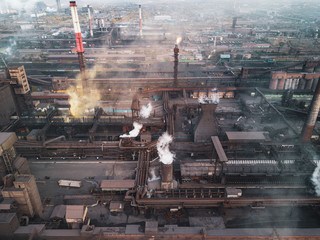 View point of smoking chimney with yellow white black colors; burning fire and smoke coming out of factory pipes; industrial zone with dirty air and fog; polluted area; unhealthy hazardous production