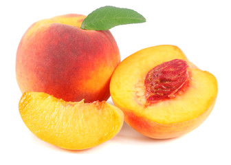 peach fruit with green leaf and slices isolated on white background