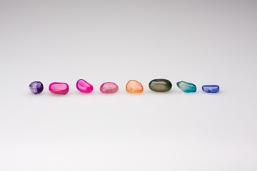 Colorful natural gem stones alighed and Isolated on neutral white