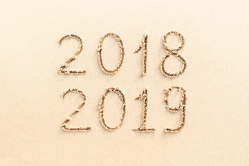 2018 and 2019 handwritten on the sand