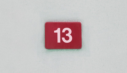 number 13 sign on the wall, bad luck concept