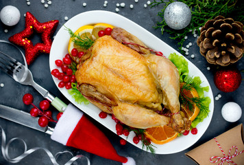 Christmas chicken on festive table with decorations