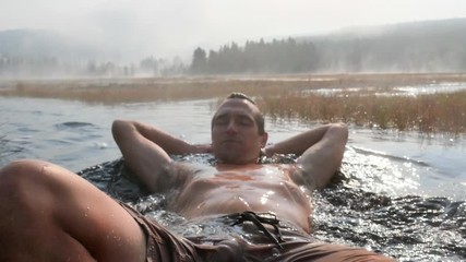 Close-Up: Man Laying in a Hot Spring - Powered by Adobe