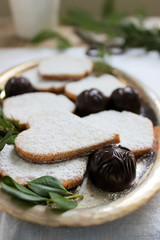 Gingerbread cookies, candy and cocoa, decorated with spruce and boxwood branches.