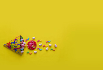 Candy caramel on a yellow background. Celebration.