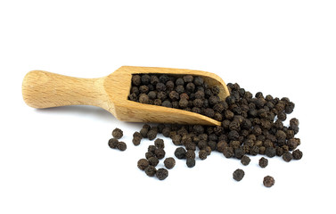Black pepper on wooden scoop isolated on white background
