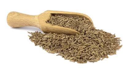 Cumin seed on wooden scoop isolated on white background