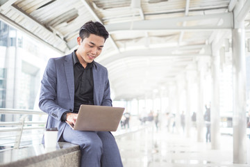 Young business man  use notebook laptop for internet social network work project in city.