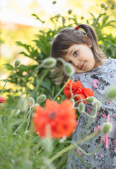 Portrait of a three year old little girl outdoor in  garden.