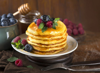 Stack of pancakes with fresh berries, close-up.