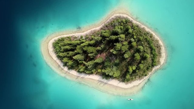 Aerial Lockdown: Small Island Explored by Man on a Kayak