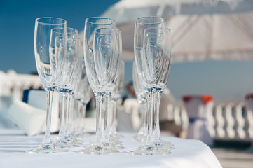 many empty wineglasses in rows at white table. welcome drink. catering