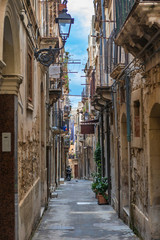 Narrow street Ortigia. Small island which is the historical centre of the city of Syracuse, Sicily. Italy.