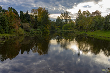 Autumn foliage casts reflection on the calm waters