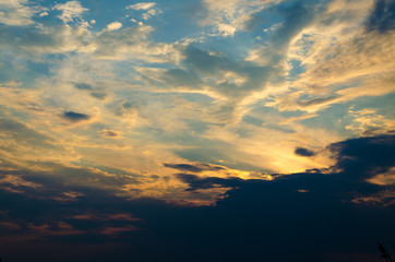 Yellow evening sunset in the sky with clouds