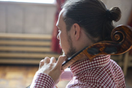 Cello playing cellist hands close up orchestra instruments