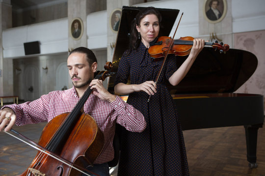 Two violinists performing together hands close up