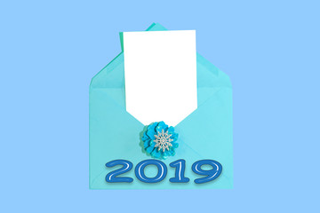 Christmas and new year card with blue envelope and blank white paper sheet for text, holiday background

