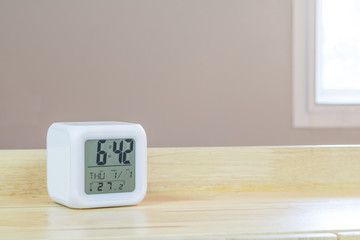 LED alarm clock standing on table background. Digital timer display. Copyspace for your design.