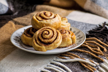 Cinnamon rolls buns with spices and cocoa. Kanelbulle - swedish sweet homemade dessert. Christmas baking pastry.