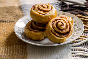 Cinnamon rolls buns with spices and cocoa. Kanelbulle - swedish sweet homemade dessert. Christmas baking pastry.