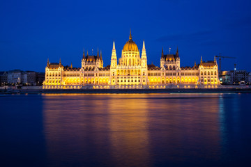 Fototapeta na wymiar travel and european tourism concept. Budapest, Hungary. Hungarian Parliament Building over Danube River illuminated at night.