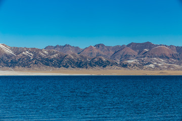   The frozen Sailimu lake with snow mountain background at Yili, Xinjiang of China