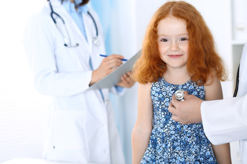 Doctor examining a little girl with stethoscope.Medicine and healthcare concept