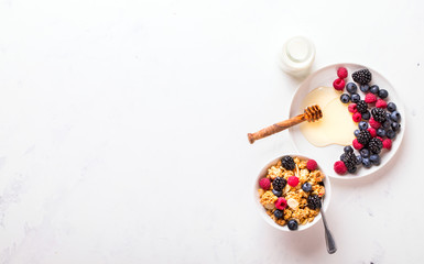 Granola Cereal bar with Strawberries blueberries and Milk on light Background . Muesli Breakfast. Healthy Food sweet dessert snack. Diet Nutrition Concept. Vegetarian food. Flat Lay. Copy space