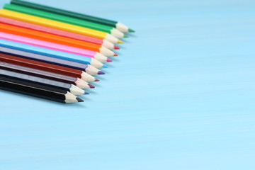 Colored pencils on blue background.