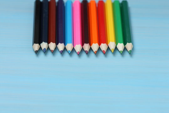 Colored pencils on blue background.