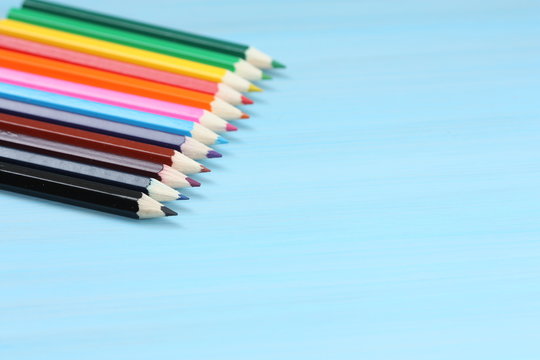 Colored pencils on blue background.