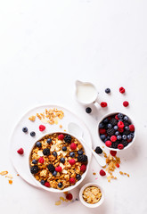 Granola Cereal bar with Strawberries blueberries and Milk on light Background . Muesli Breakfast. Healthy Food sweet dessert snack. Diet Nutrition Concept. Vegetarian food. Flat Lay. Copy space
