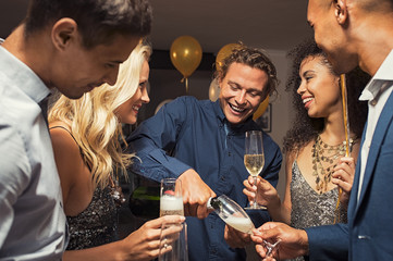 Man pouring champagne in flutes
