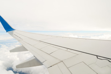 Wing of the plane on a background of cloudy sky Free space for tex