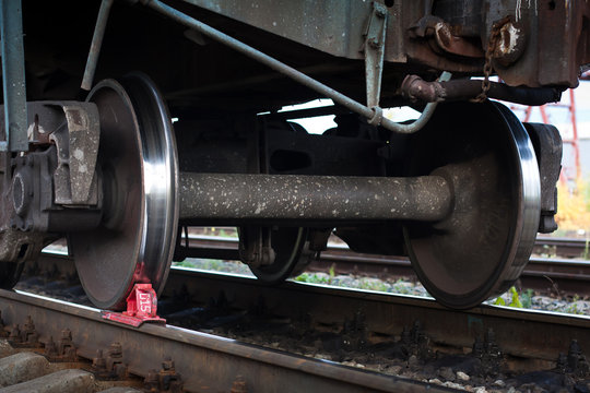 red railway brake shoe under the train wheel