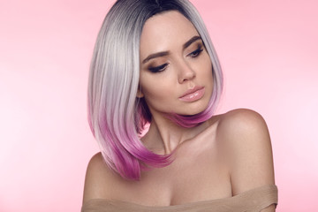 Obraz na płótnie Canvas Ombre bob short hairstyle. Beautiful hair coloring woman. Trendy puprle haircut. Blond model with short shiny haircuts isolated on pink Background. Makeup. Beauty Salon.