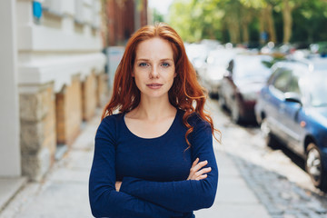 Thoughtful calm young woman staring at the camera