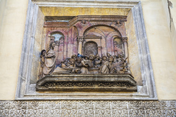 Christian sculptural representation on the facade of a church in Seville, Spain.