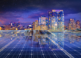 Solar panel over cityscape nightlight background. solar power green energy for life concept 