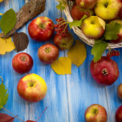 Autumn bright background. Flowers, leaves and fruits on a blue wooden background. Background for the autumn holidays and thanksgiving day.