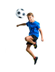 A full-length shot of Boy playing soccer hitting the ball with the head on isolated white background