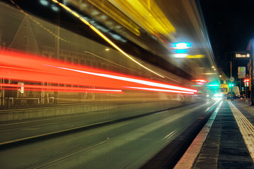Fototapeta na wymiar Time Exposure train close traffic light night Mannheim street bulb fast autumn urban public transport seckenheim