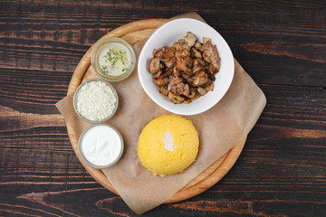 Traditional moldavian meal - hominy with fried meat, white cheese and sauce
