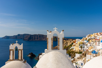 Fototapeta na wymiar Santorini, Greece. Picturesque view of traditional cycladic Santorini's church on cliff