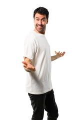 Young man with white shirt proud and self-satisfied in love yourself concept on isolated white background