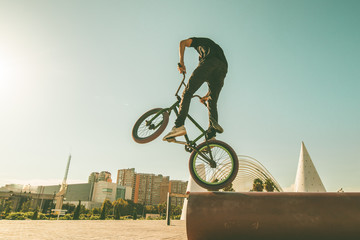 BMX rider doing tricks in the streets
