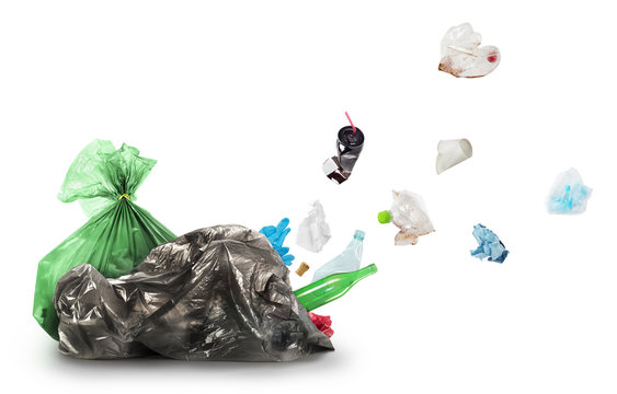 Eco concept. Out of a garbage bag, trash takes off, isolated on a white background. The concept of recycling garbage.