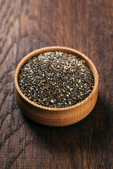 Chia seeds in a wooden bowl, closeup